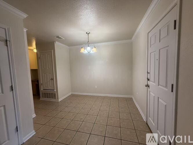 A room with white walls and a tiled floor.