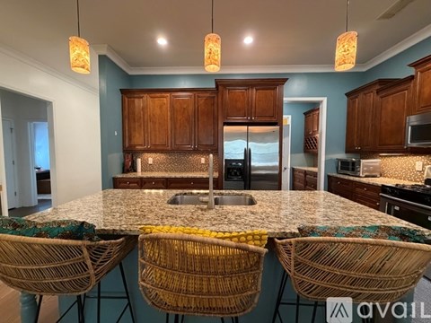 A kitchen with a table and chairs in the foreground.