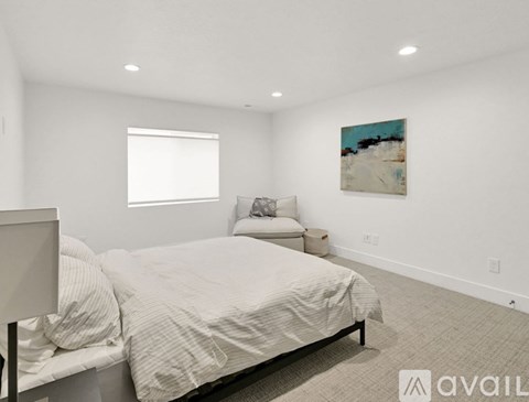 A bedroom with two beds and a painting on the wall.