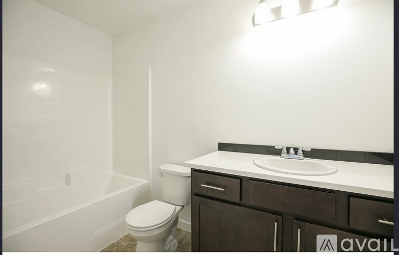 A white toilet sits next to a sink in a bathroom.