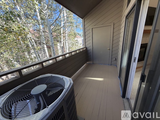 A balcony with a fan and a door.