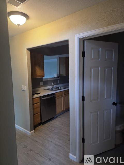 A kitchen with a white door is visible.