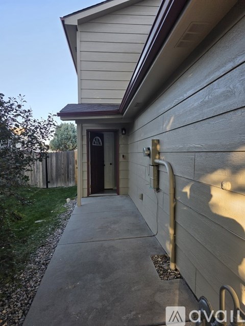 A small building with a door and a sign on the wall.