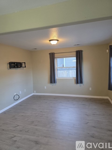 A room with a window and a light on the ceiling.