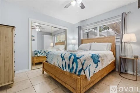 A bedroom with a bed, a dresser, and a mirror.