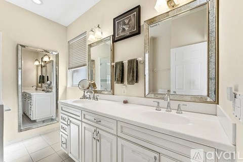 A bathroom with a vanity and a large mirror.