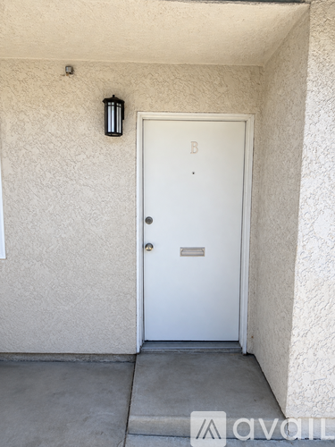 A white door with a letter B above it.