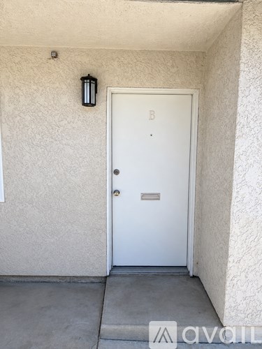 A white door with a letter B above it.