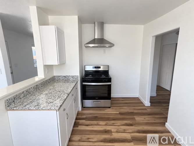A kitchen with a stove top oven and a counter top.