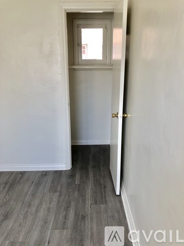A hallway with a door and a window.