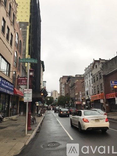 A street view of Hutchinson St with cars and buildings on either side.