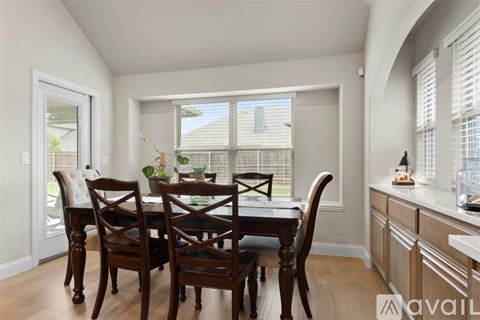 A dining room with a table set for four.