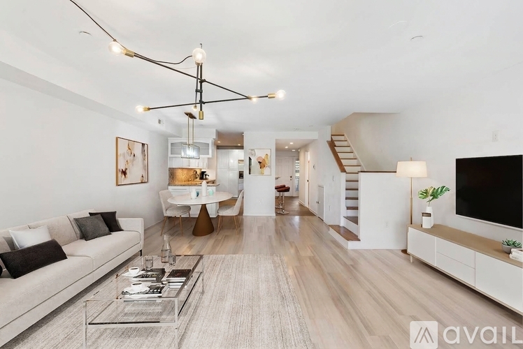 A modern living room with a white sofa and a glass coffee table.