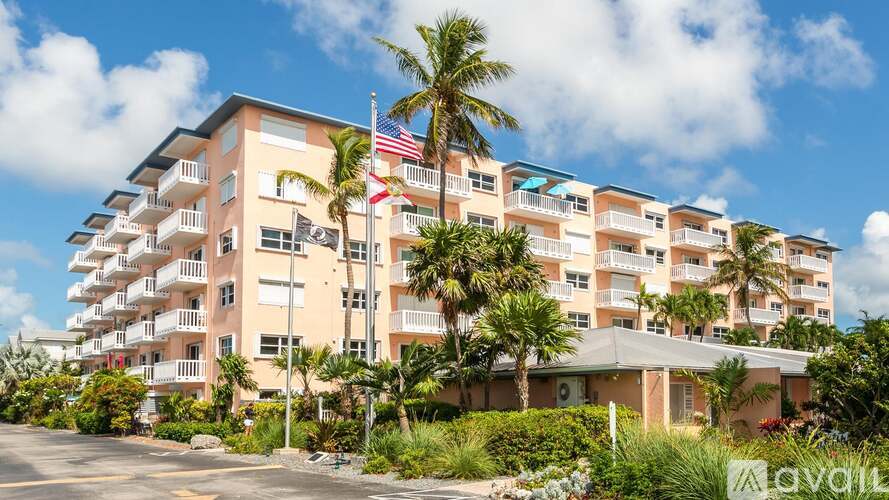 A large apartment building with a flag on the second floor.