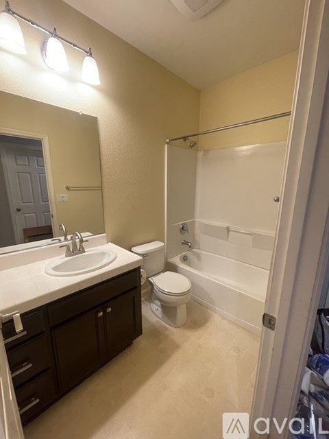 A bathroom with a sink, toilet, and bathtub.