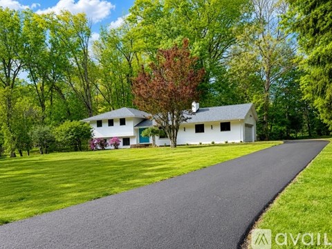 A house with a driveway in front of it.