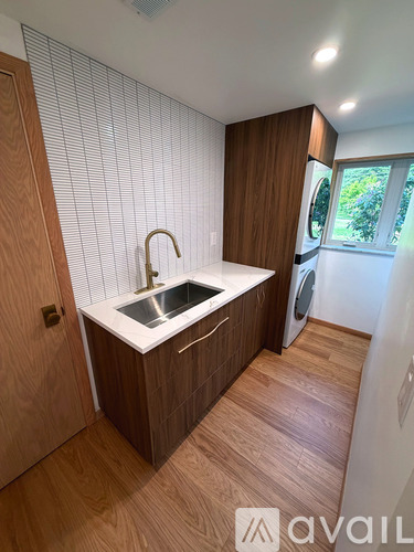 A modern kitchen with wooden cabinets and a white countertop.