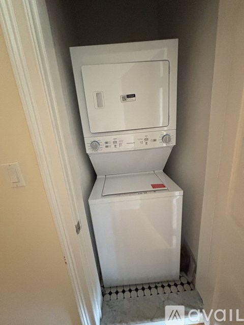 A white washing machine in a small laundry room.