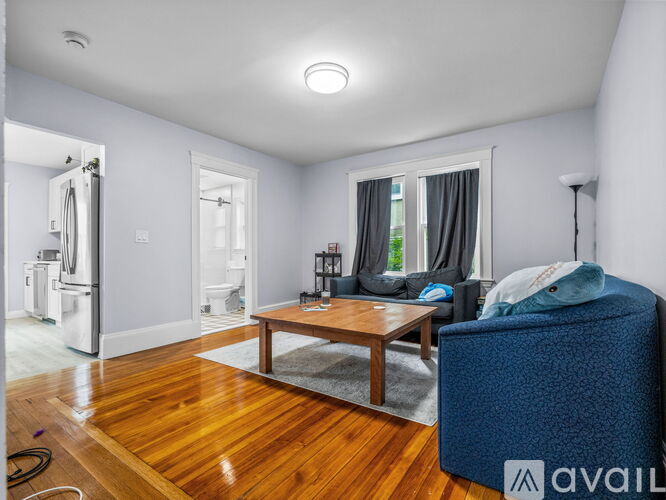 A living room with a blue sofa and a wooden coffee table.