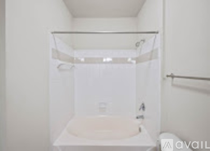A white bathroom with a glass shower door.