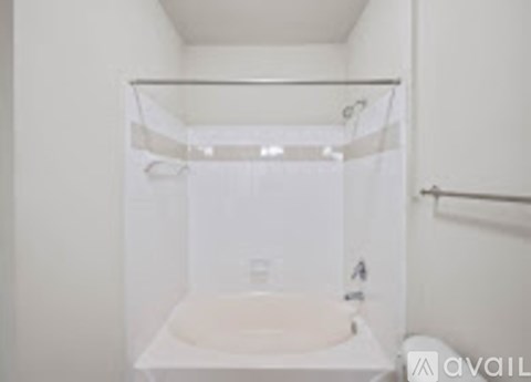 A white bathroom with a glass shower door.