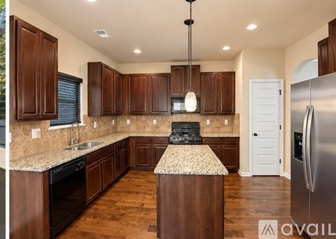 A kitchen with wooden cabinets and a granite countertop.
