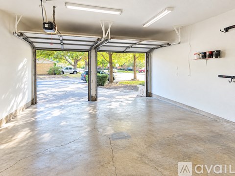 A spacious garage with a concrete floor and white walls.