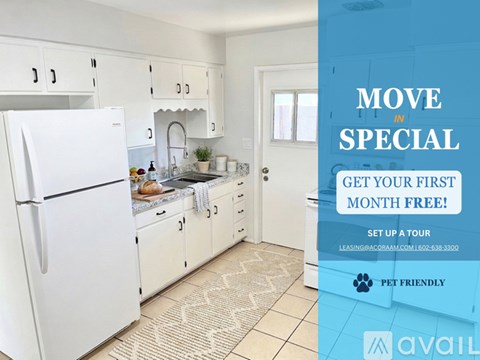 A kitchen with a refrigerator, sink, and cabinets is on display for a move-in special.