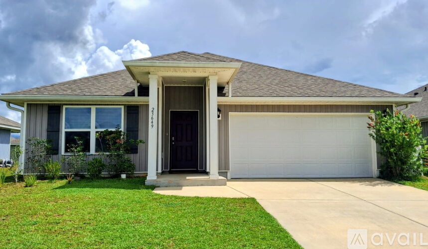 A house with a brown roof and a black front door.