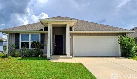A house with a brown roof and a black front door.