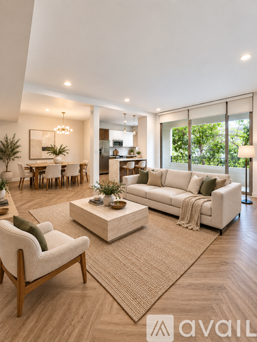 A living room with a white sofa, a wooden armchair, and a coffee table.