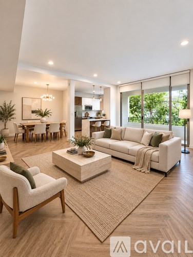 A living room with a white sofa, a wooden armchair, and a coffee table.
