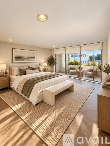A bedroom with a large bed and a painting on the wall.