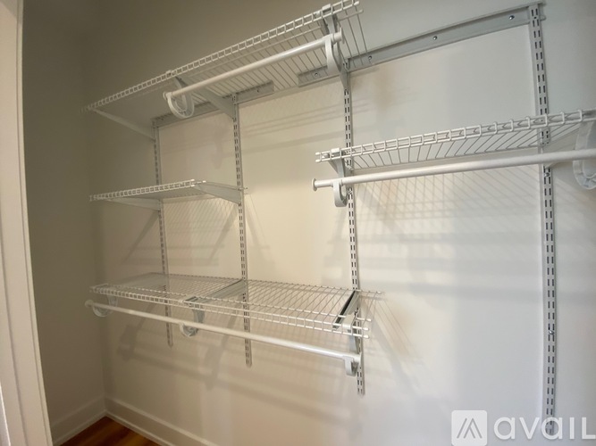 Empty shelves in a white pantry.