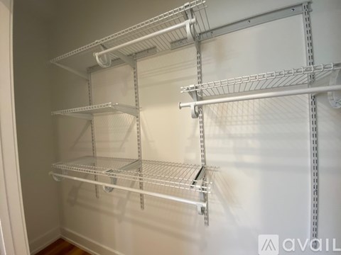 Empty shelves in a white pantry.