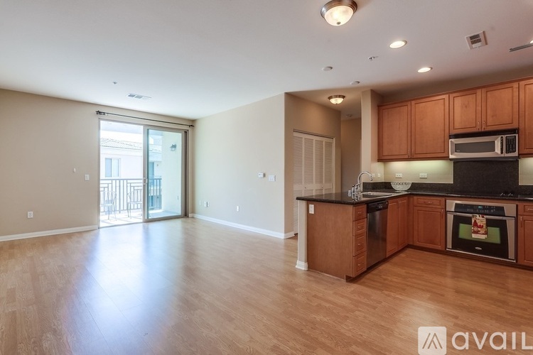 A kitchen with wooden cabinets and a microwave above the stove.