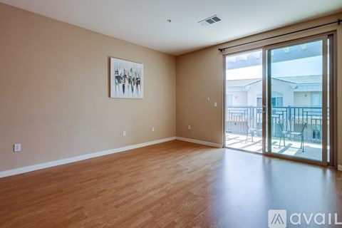 A room with wooden flooring and a painting on the wall.