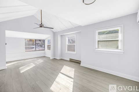 A spacious room with a ceiling fan and a window.