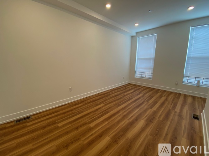 A room with wooden flooring and a window.