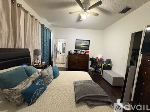 A bedroom with a bed, dresser, and mirror.