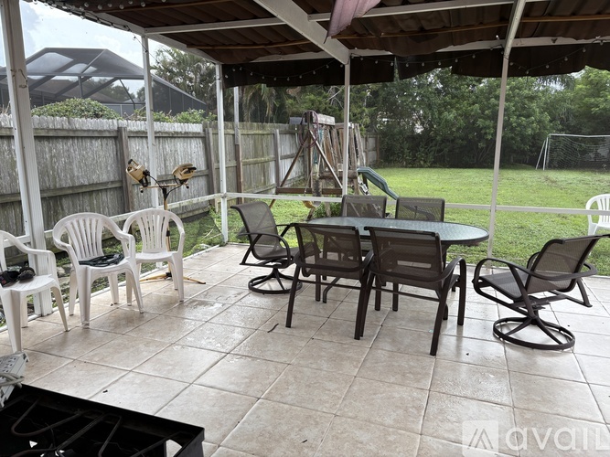 A patio with a table and chairs.