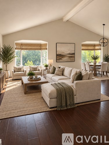A living room with a couch, chairs, and a coffee table.