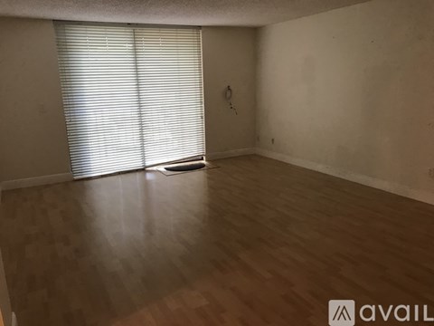 Empty room with wooden floor and white walls.