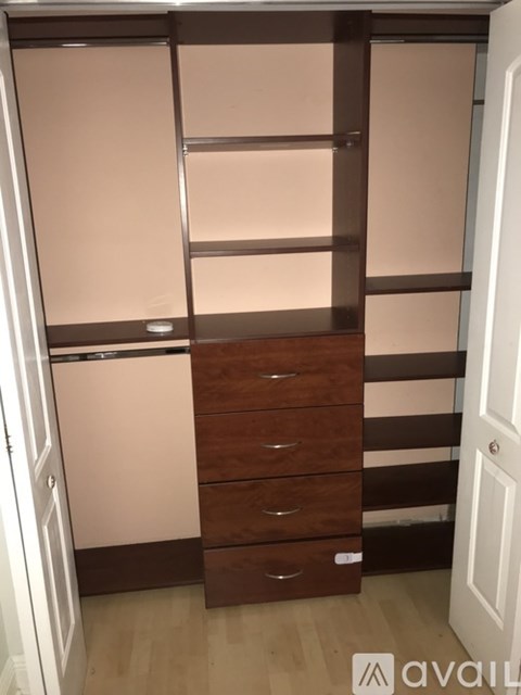 A brown and white wardrobe with drawers and shelves.