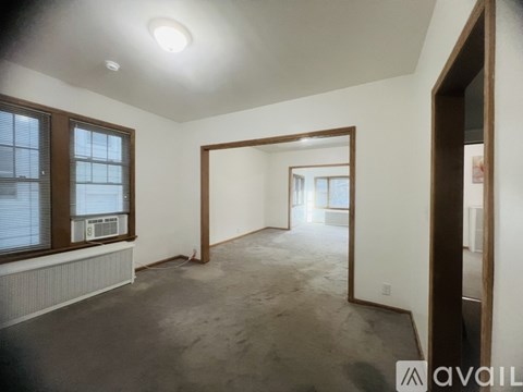 A spacious empty room with a large mirror on the wall.