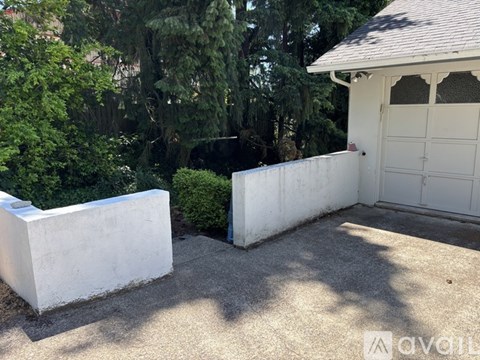 A white garage door is on the right side of the image.