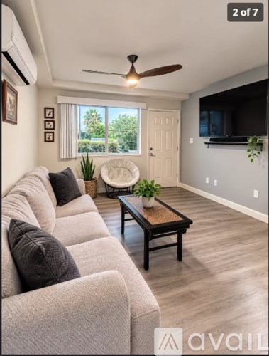 A living room with a grey couch and a brown coffee table.