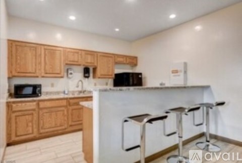 A kitchen with wooden cabinets and a white counter.