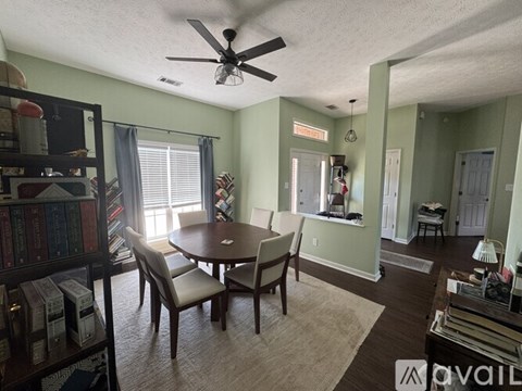 A living room with a dining table and chairs.