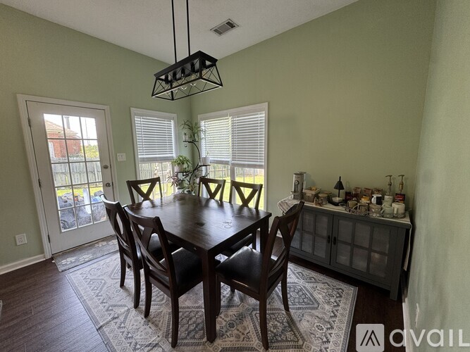 A dining room with a table set for six.